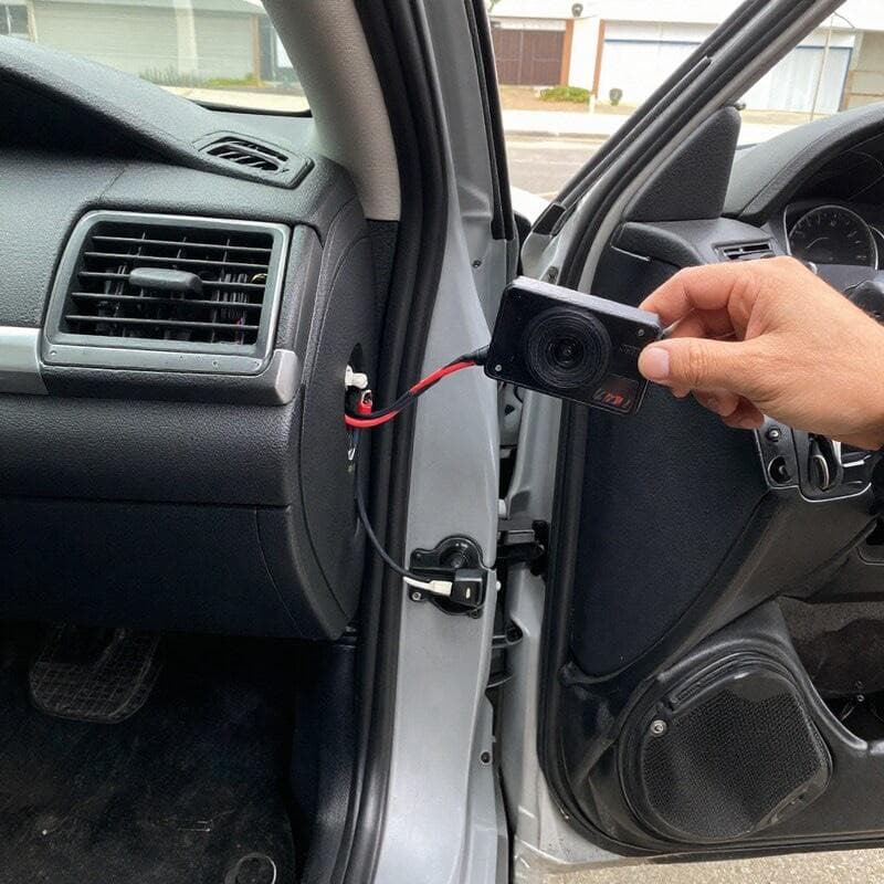Tint Bros Adelaide technician hardwiring a front dashcam to a vehicle's fuse box with clean cable routing behind the A-pillar trim